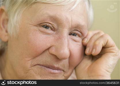 Elderly woman with short grey hair smiling