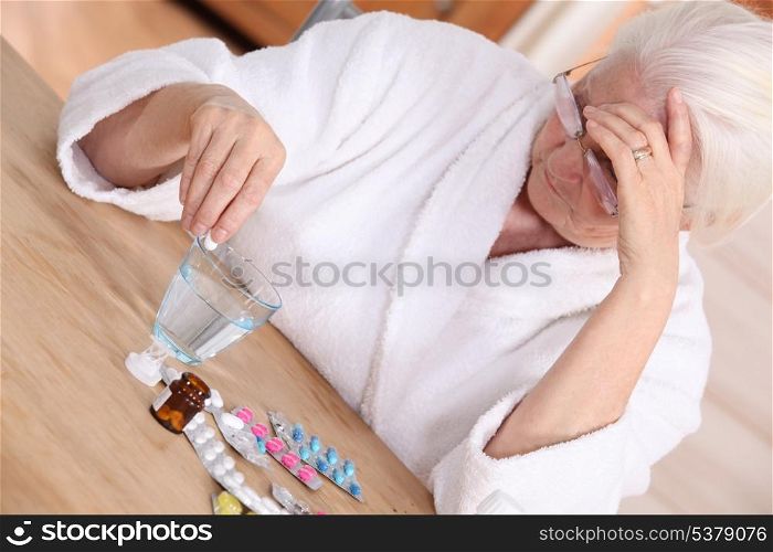 Elderly woman with various medications