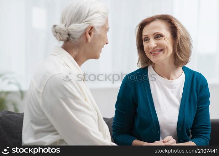 elderly women looking each other