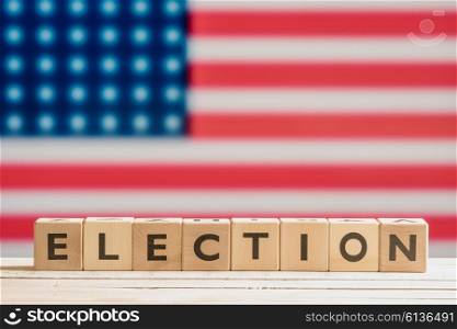 Election sign on a table with the american flag