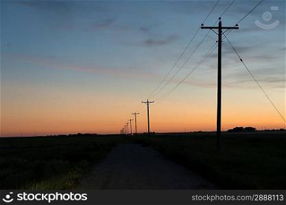 Electric cable line in a prairie field, Manitoba, Canada