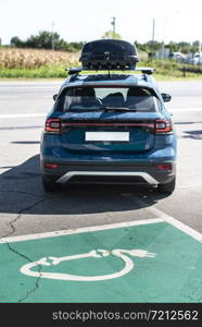 Electric car on gas station. Blue car and electric plug for charging. Ecology green fuels concept.