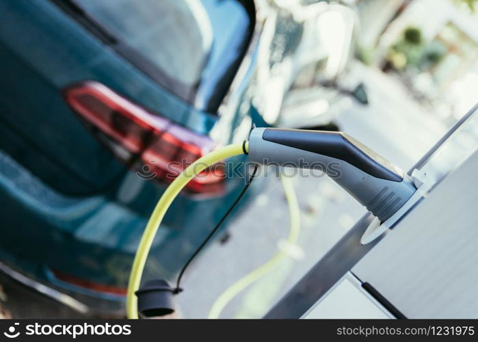 Electric car recharging with charge cable and plug leading to charge point