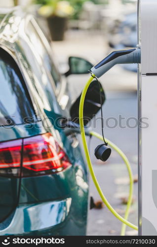 Electric car recharging with charge cable and plug leading to charge point