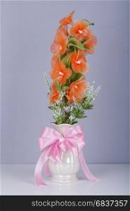 electric flower in vase on table with wall background