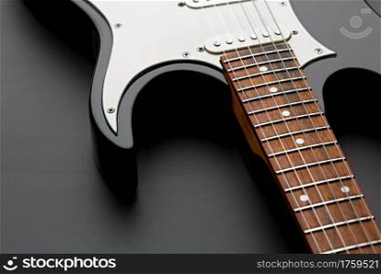 Electric guitar closeup, black background, nobody. String musical instrument, electro sound, electronic music, equipment for stage concert. Electric guitar closeup, black background, nobody
