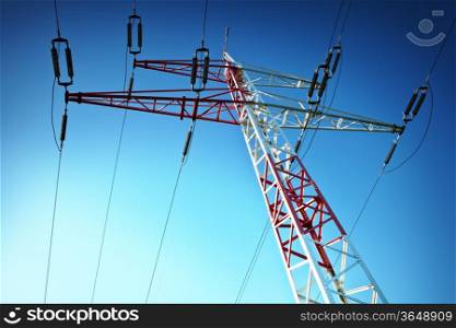 Electric high voltage pylon against blue sky