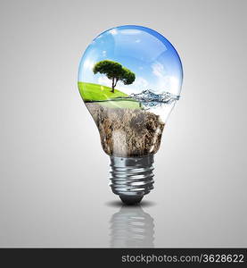 Electric light bulb and a plant inside it as symbol of green energy