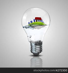 Electric light bulb and a plant inside it as symbol of green energy