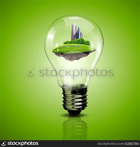 Electric light bulb and a plant inside it as symbol of green energy