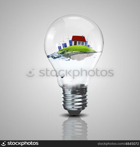 Electric light bulb and a plant inside it as symbol of green energy