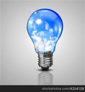 Electric light bulb and blue sky with clouds inside it