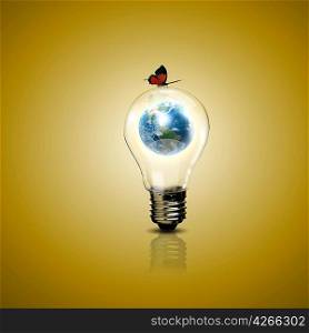 Electric light bulb and our planet inside it as symbol of green energy
