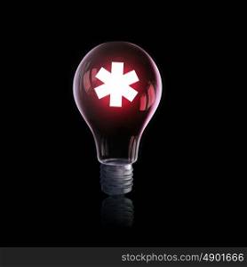 Electric light bulb. Glass light bulb with sign on dark background