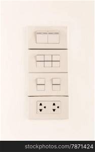 Electric light switches or switchboard and sockets on wall background, turn off position