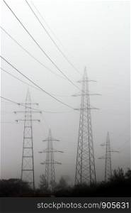 Electric masts in the foggy day