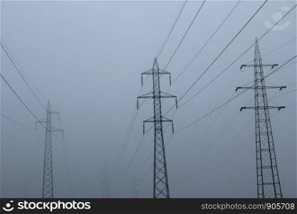 Electric masts in the foggy day