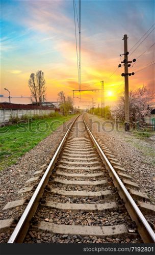 Electric poles on a railway station at sunrise