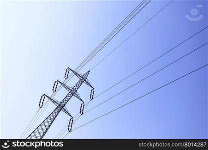 Electric power line over deep blue sky