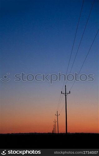 electric power lines in sunset blue red orange sunrise