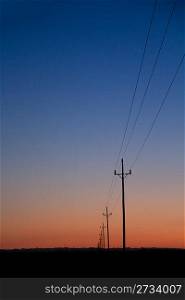 electric power lines in sunset blue red orange sunrise