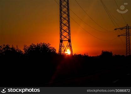 Electric power pylon, electric tower at sunset