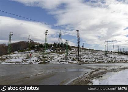 Electric power transmission line in winter, Plana mountain, Bulgaria