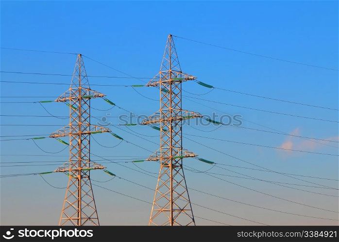 electric power transmission towers at sunrise