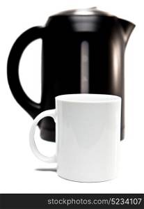 electric tea kettle on a white background and a mugFocus on a tea mug