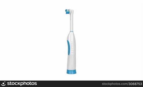 Electric toothbrush rotates on white background