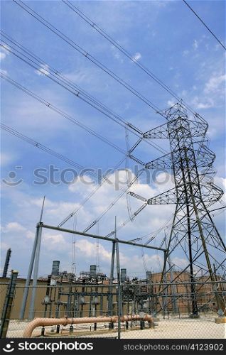 Electric tower and cables over blue sky