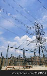 Electric tower and cables over blue sky