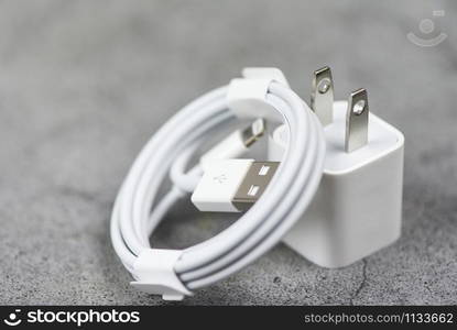 Electrical adapter smartphone usb port charger wire on gray background / Mobile Phone Charger Adapter