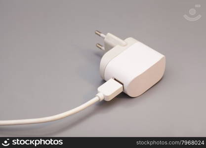 Electrical adapter to USB port on a gray background