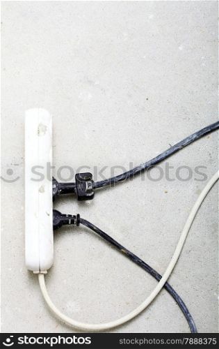 electrical cords connected to a power strip or extension block in construction site