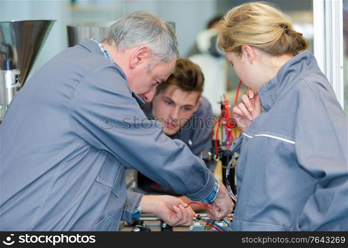electrical engineers assembling electrical parts