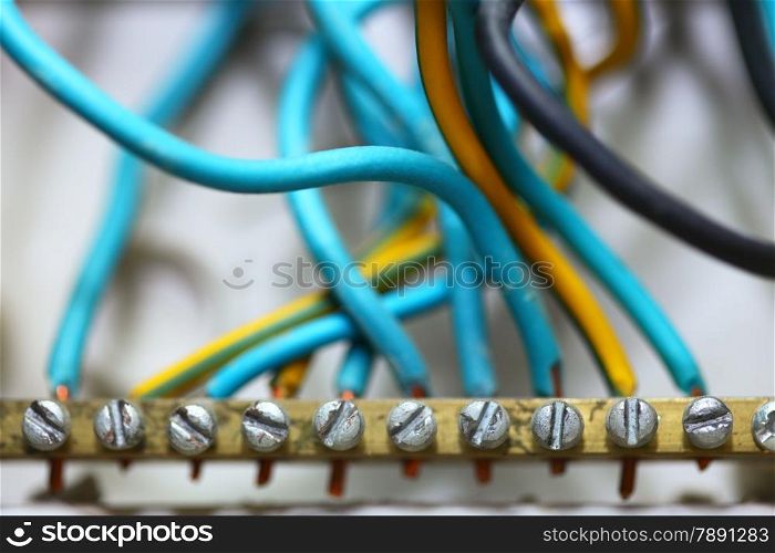 Electrical installation. Close up electric wires hanging on wall construction building site.
