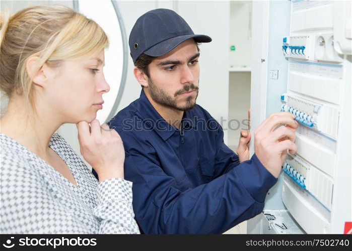 electrical man installing a fuse box
