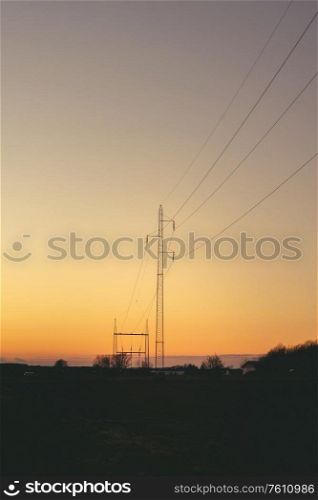 Electrical pylons at dawn in a beautiful sunset with a clear sky