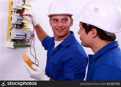 Electrical safety inspectors verifying central fuse box