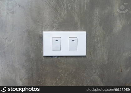 electrical switch with gray cement wall background.