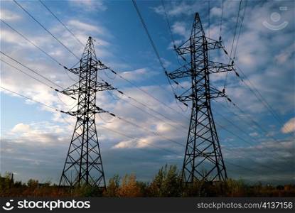 electrical tower with blue sky and white clouds