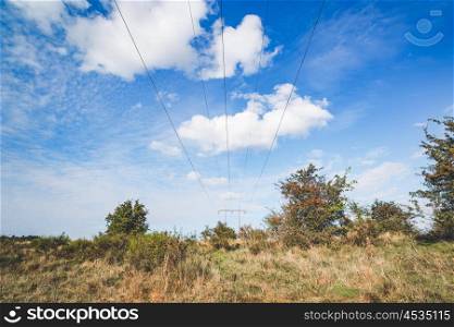 Electrical wires on a pylon in a prairie landscape