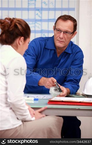electrician advising woman on outlets