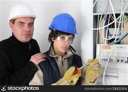 Electrician and his young apprentice