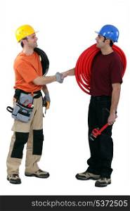 Electrician and plumber shaking hands