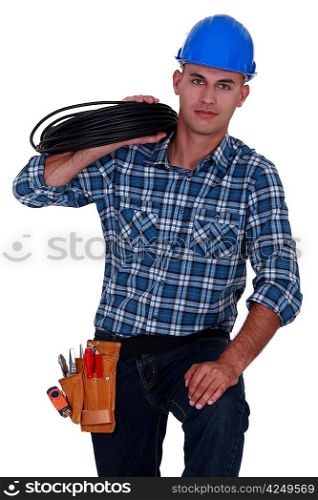 Electrician carrying spool of wiring
