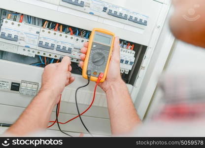 Electrician checking fusebox