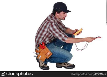electrician crouching using tester