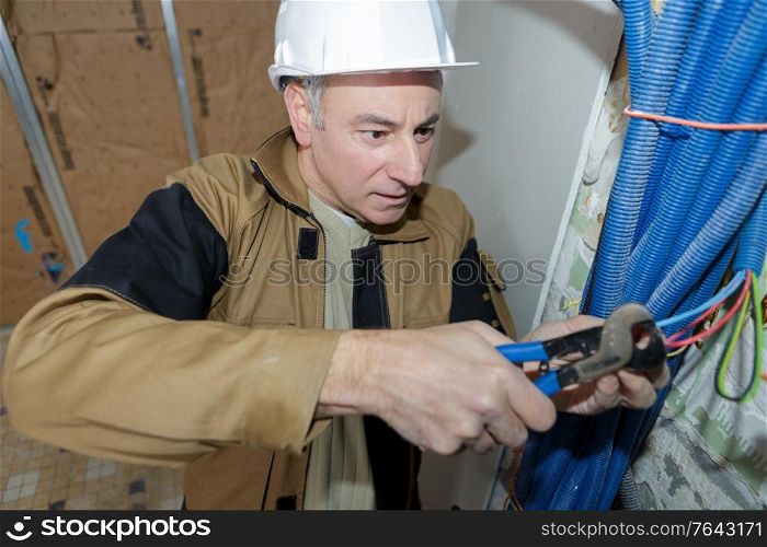 electrician cutting cables in a construction site